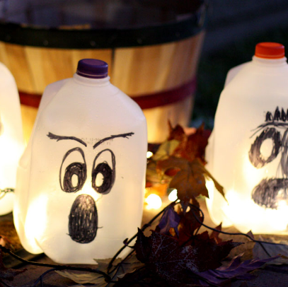 Milk jug ghost lanterns glowing with lights