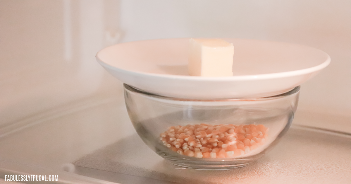 popping popcorn in a bowl with butter