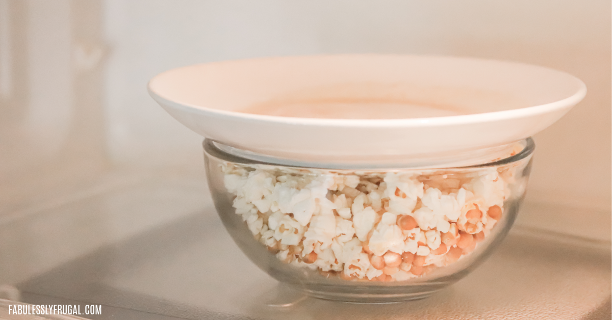 popping popcorn in the microwave in a bowl 