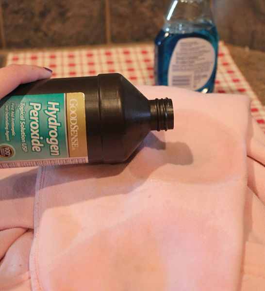 Pouring hydrogen peroxide over old oil stain