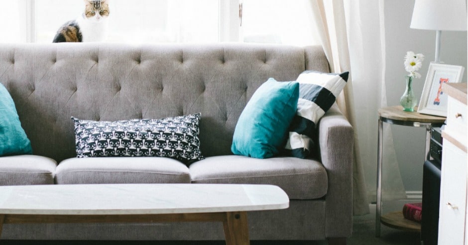 Couch in a living room with pillows and other furniture