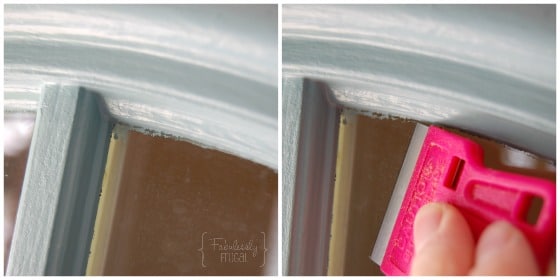 Scraping off excess paint with a razor