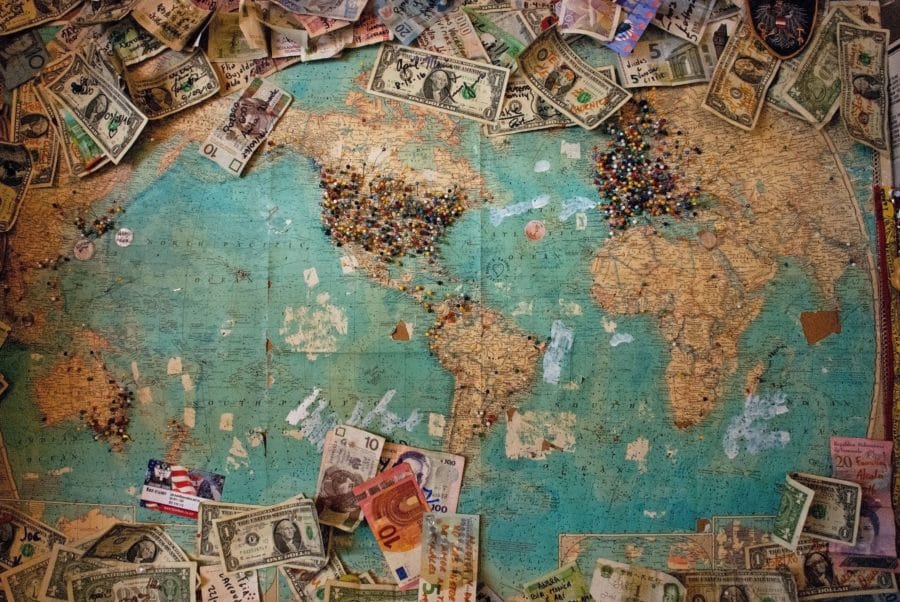 World map with money around it