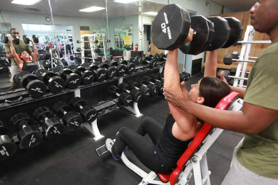 Personal trainer and woman working out