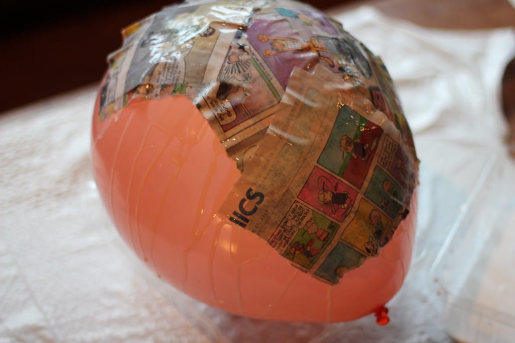 Balloon covered almost halfway with newspaper