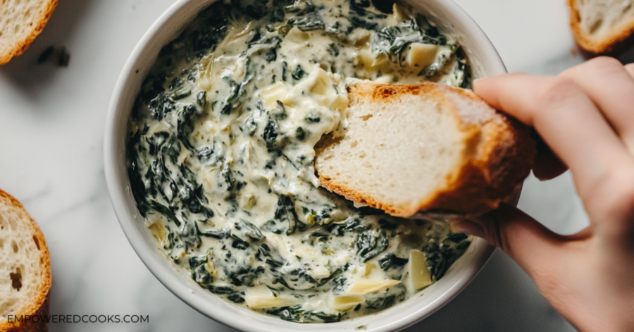 dipping bread in spinach artichoke dip