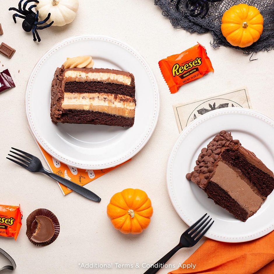 Two Cheesecake factory slices on Halloween themed counter
