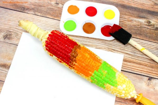 Corn on the cob with red orange and green paint on it