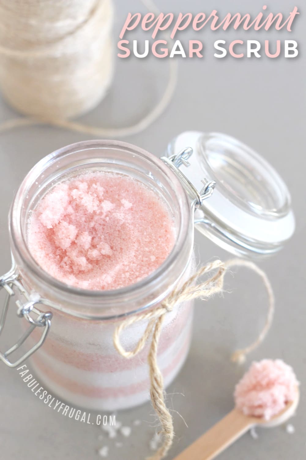 Finished jar of peppermint sugar scrub with wooden spoon
