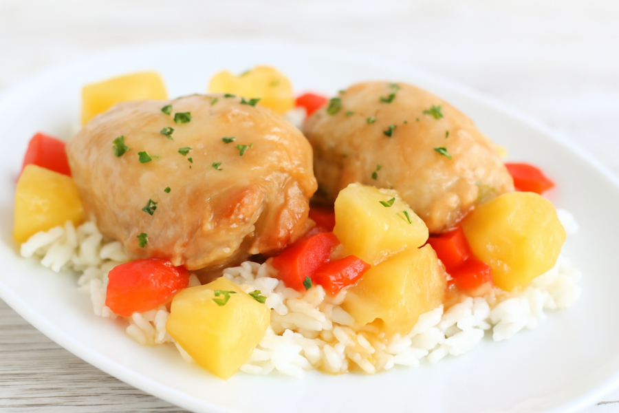 Plated Hawaiian chicken over rice with parsley garnish – fabulesslyfrugal.com branding