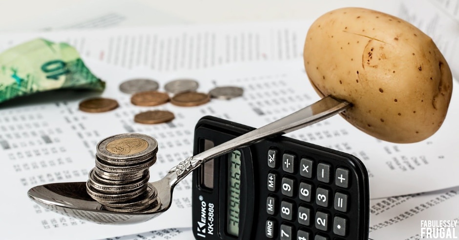 Potato being balanced by money on a calculator