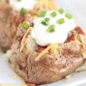 Air fryer baked potato with sour cream, cheese, bacon, and green onions