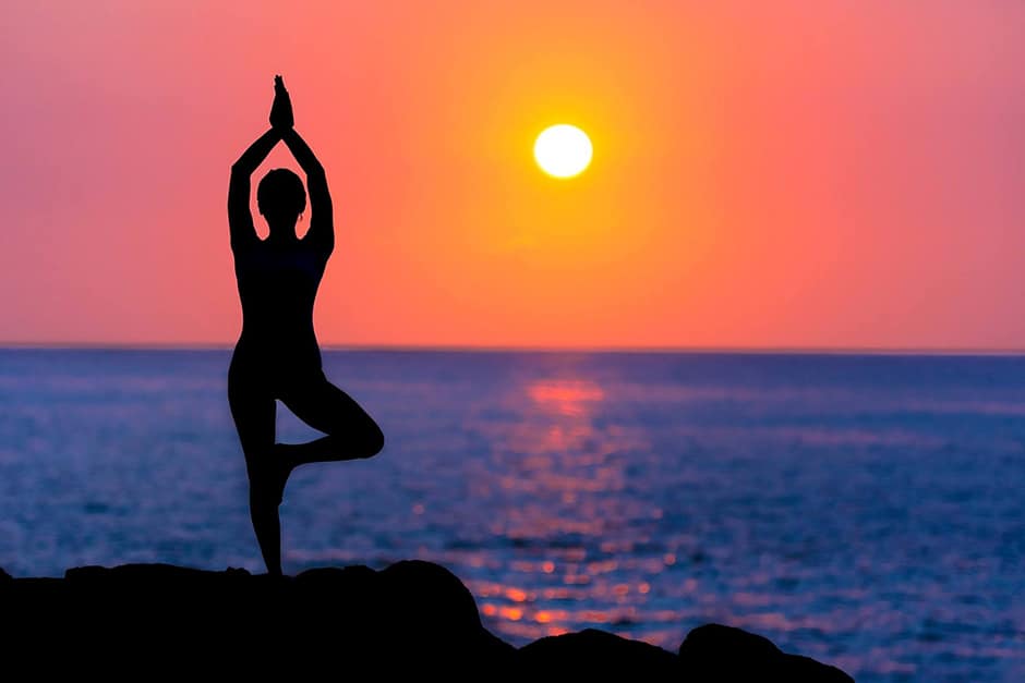 Backlit photo of a woman doing yoga
