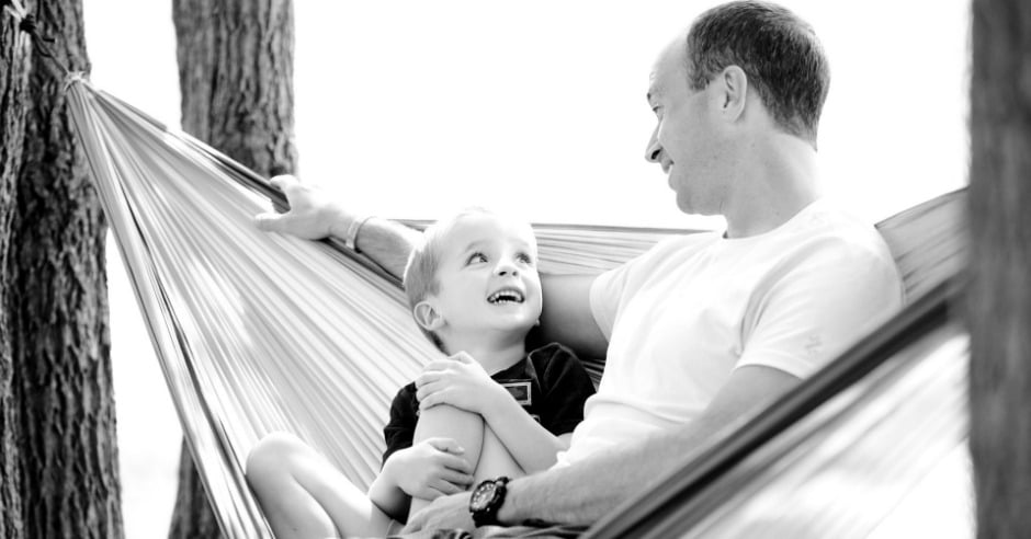 Dad and son sitting in hammock
