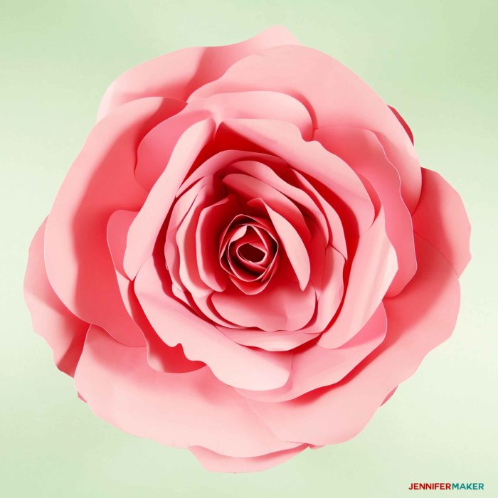 Giant paper rose on green background