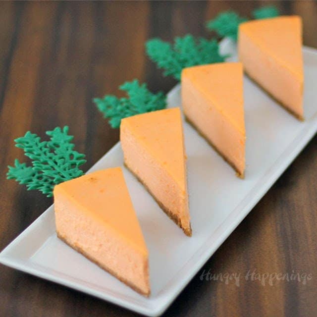 4 perfect slices of orange cheesecake with frosting greenery