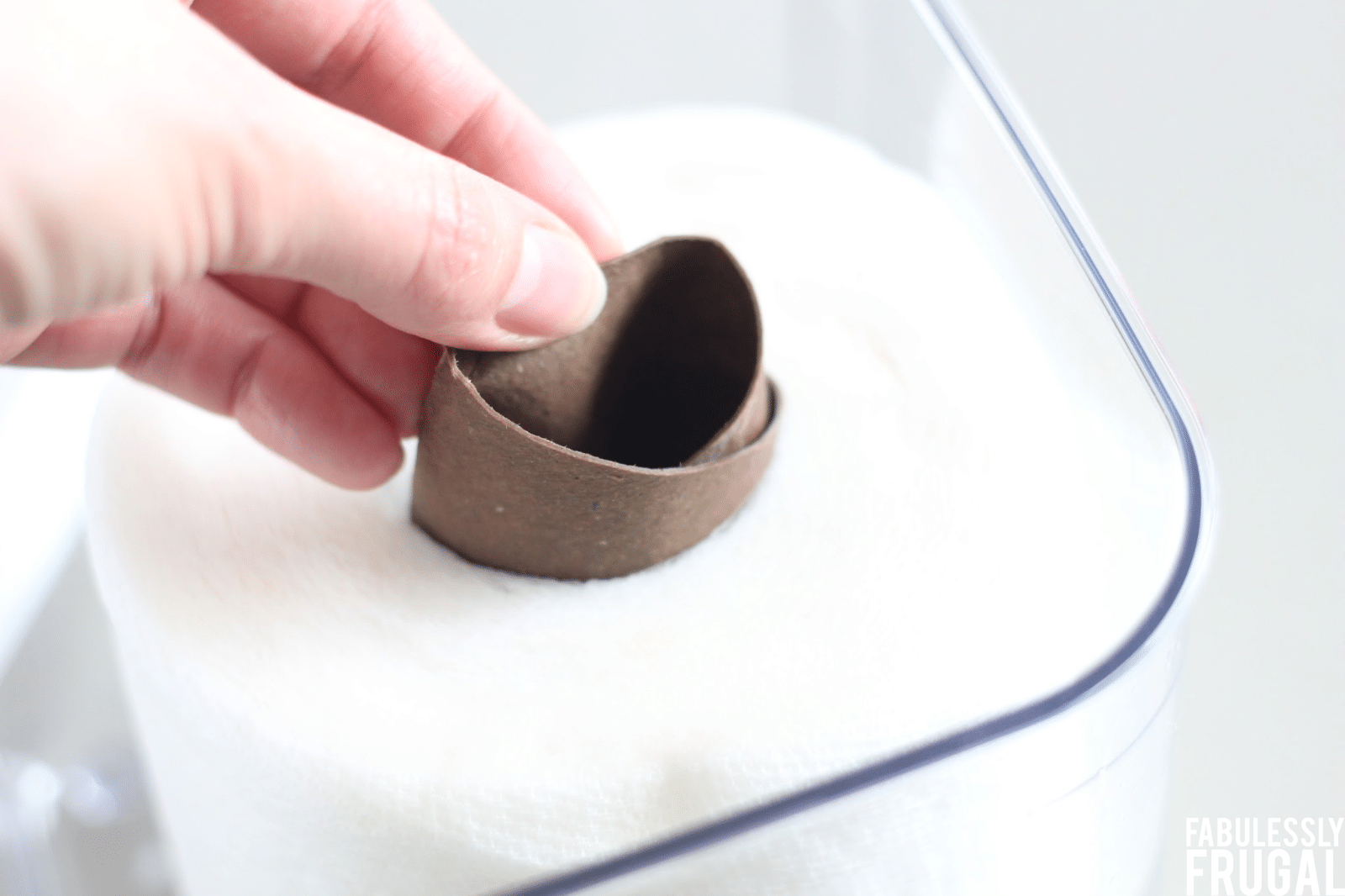 Pulling cardboard tube from paper towel roll