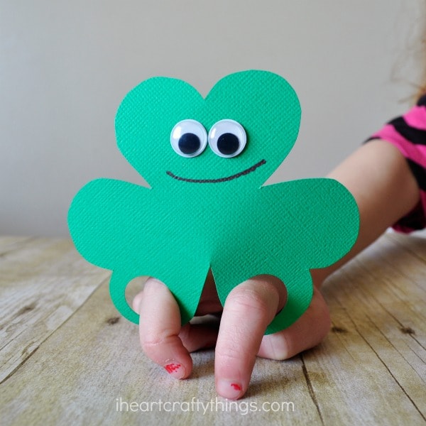 Person playing with shamrock finger puppet