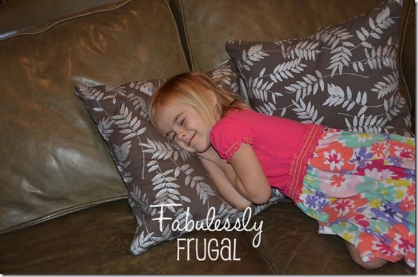 Kid lying on DIY throw pillows made from napkins