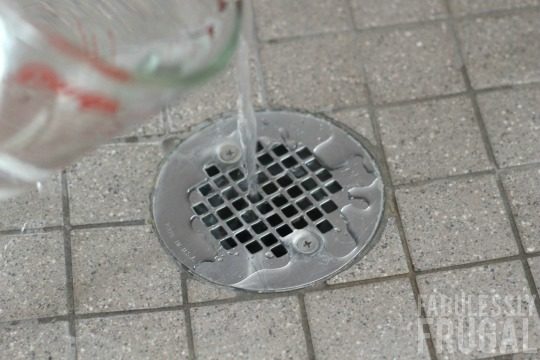Pouring vinegar down shower drain