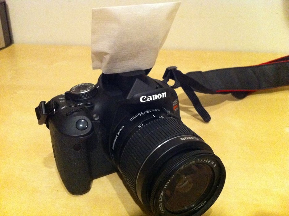Canon camera with a coffee filter over the flash