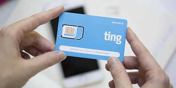 Person holding a Ting sim card