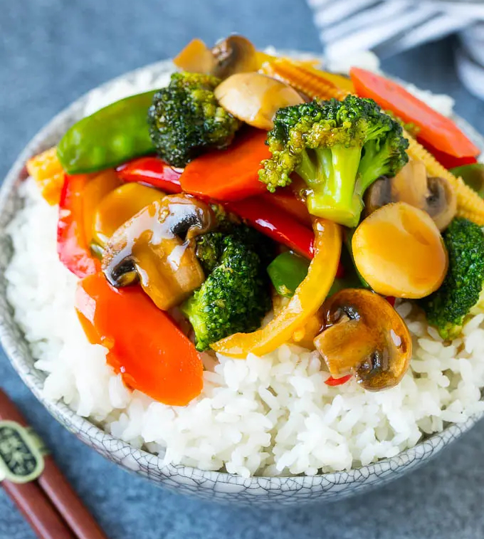 Colorful bowl of vegetable stir fry over rice
