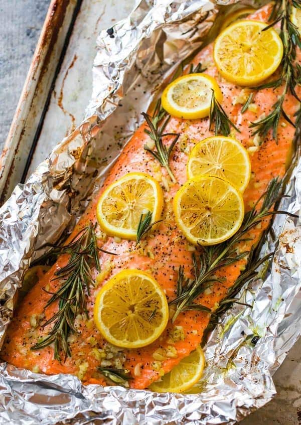 Foil wrapped salmon with lemon slices and rosemary