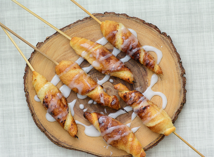Campfire cinnamon roll ups drizzled with icing