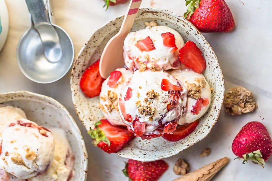 Bowl of ice cream with strawberries and crumble