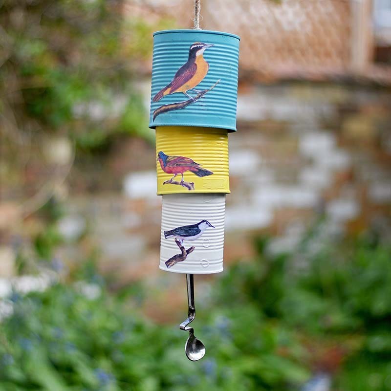 Different sized tin cans with birds painted on