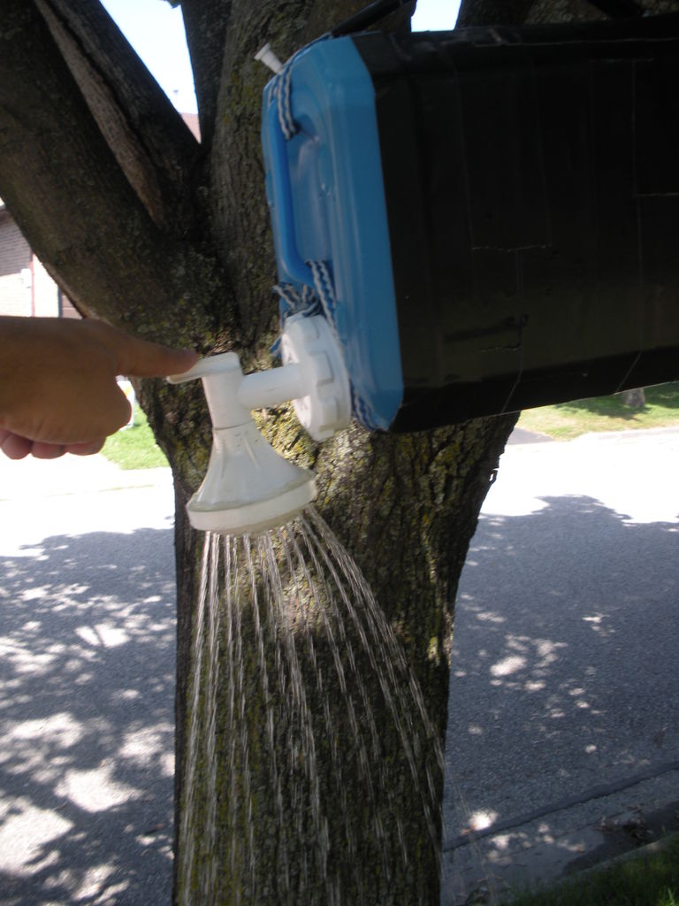 DIY camping shower hooked up to a tree