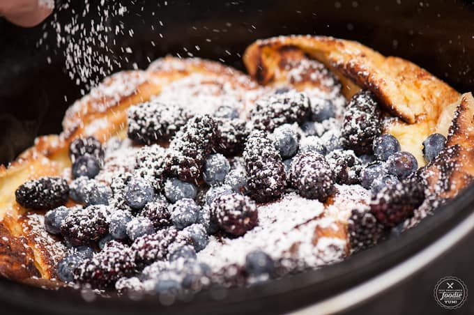 Dutch oven dutch baby with fruits and powdered sugar