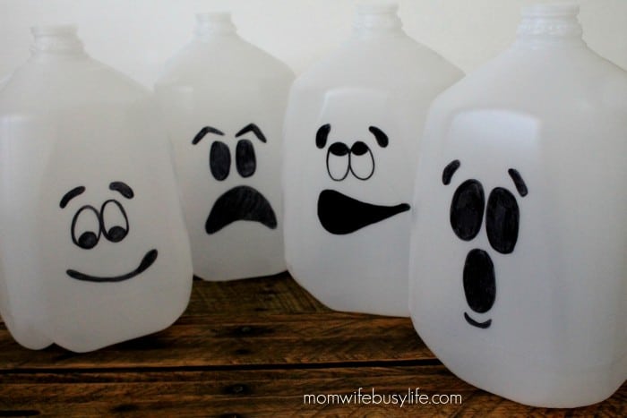 Fun ghost faces drawn onto milk jugs