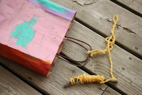 Colored paper bag with string and handle attached