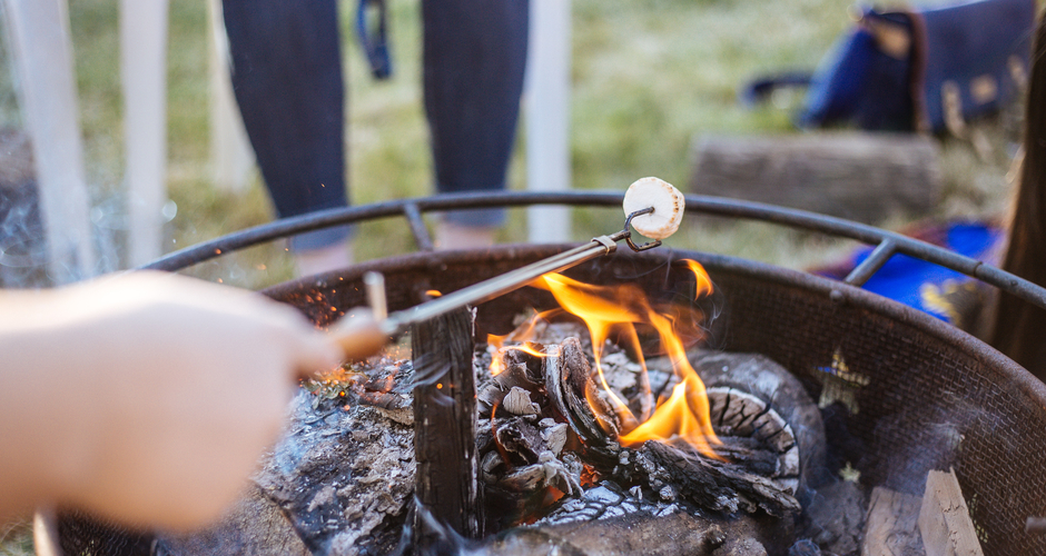 Person roasting a marshmallow over a fire