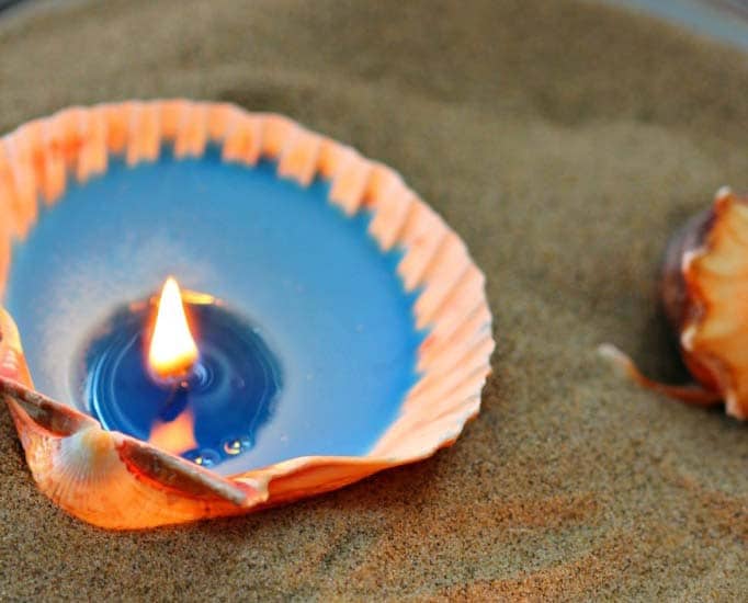 Burning candle inside of a seashell