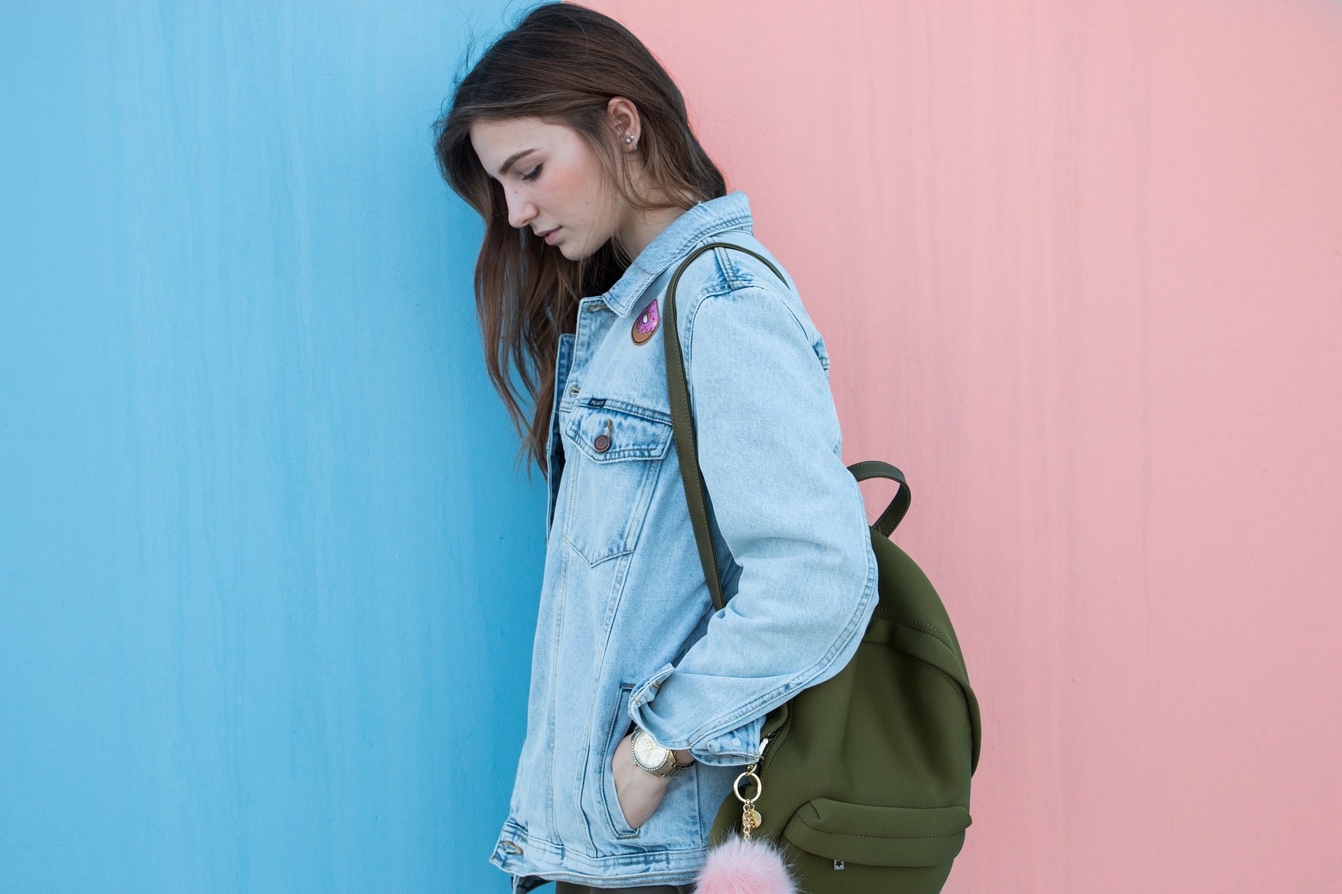 College girl standing in front of a blue and pink wall