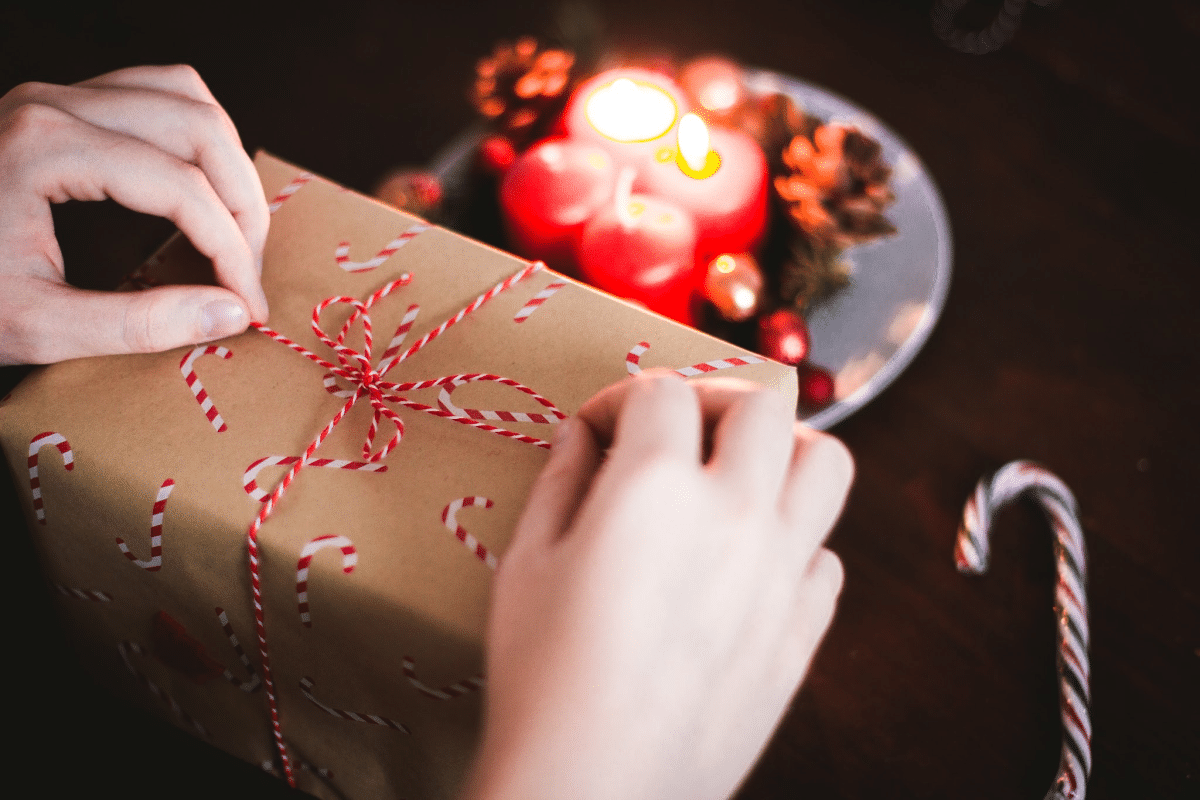 Christmas gift wrapped in brown paper with candy canes on it