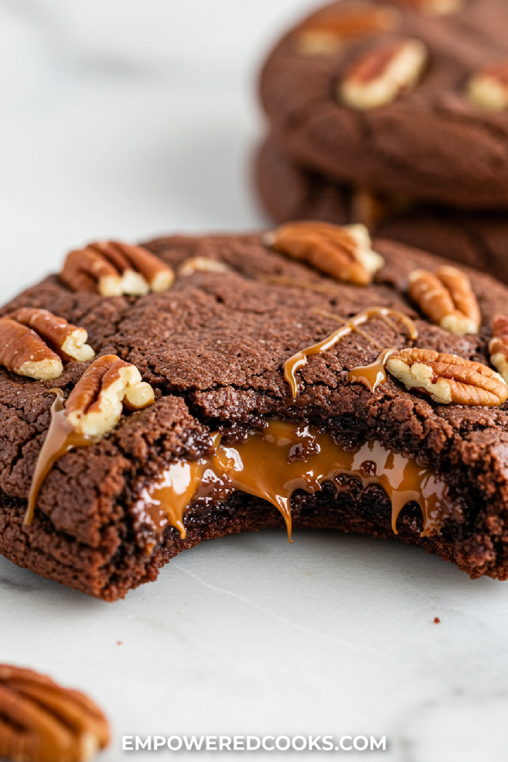 a bite out of a turtle brownie cookie