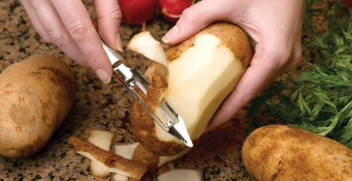 Person peeling potatoes