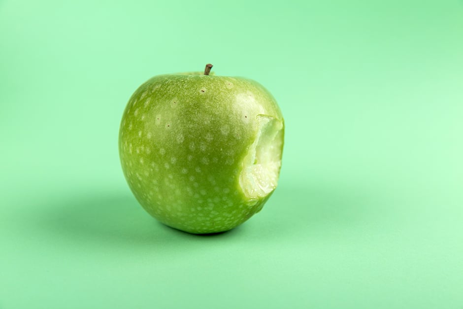 Green apple on green background