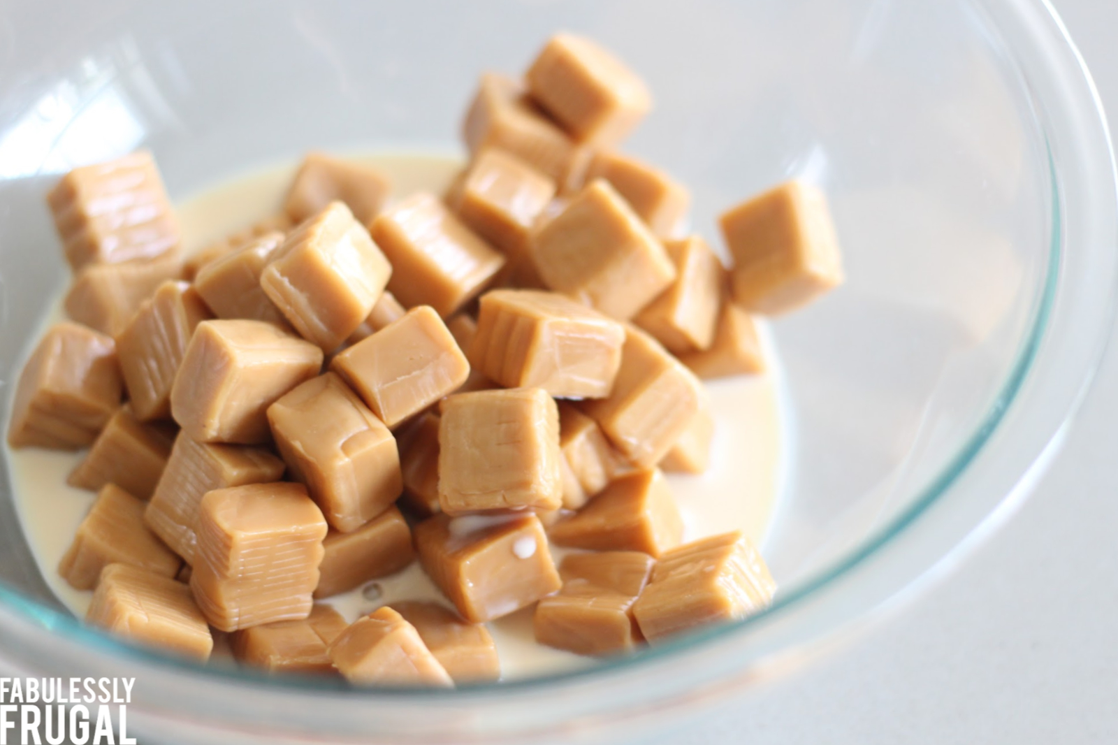 Caramels and evaporated milk in glass mixing bowl