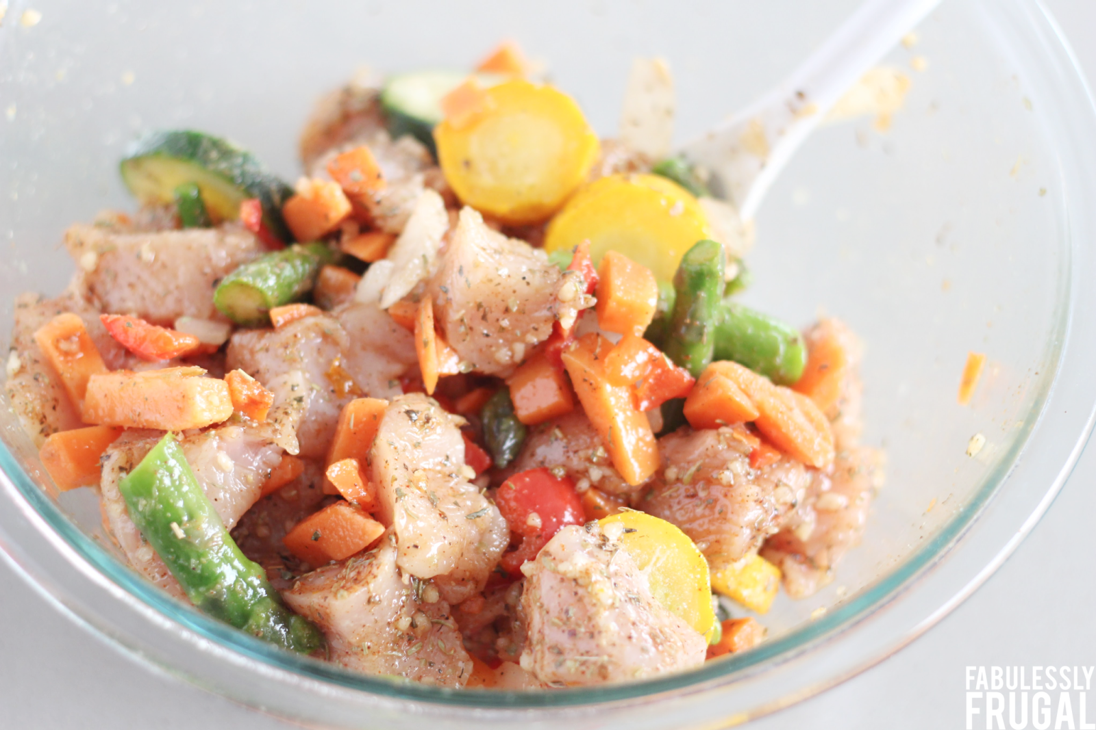 mix chicken and veggies with seasoning for air fryer