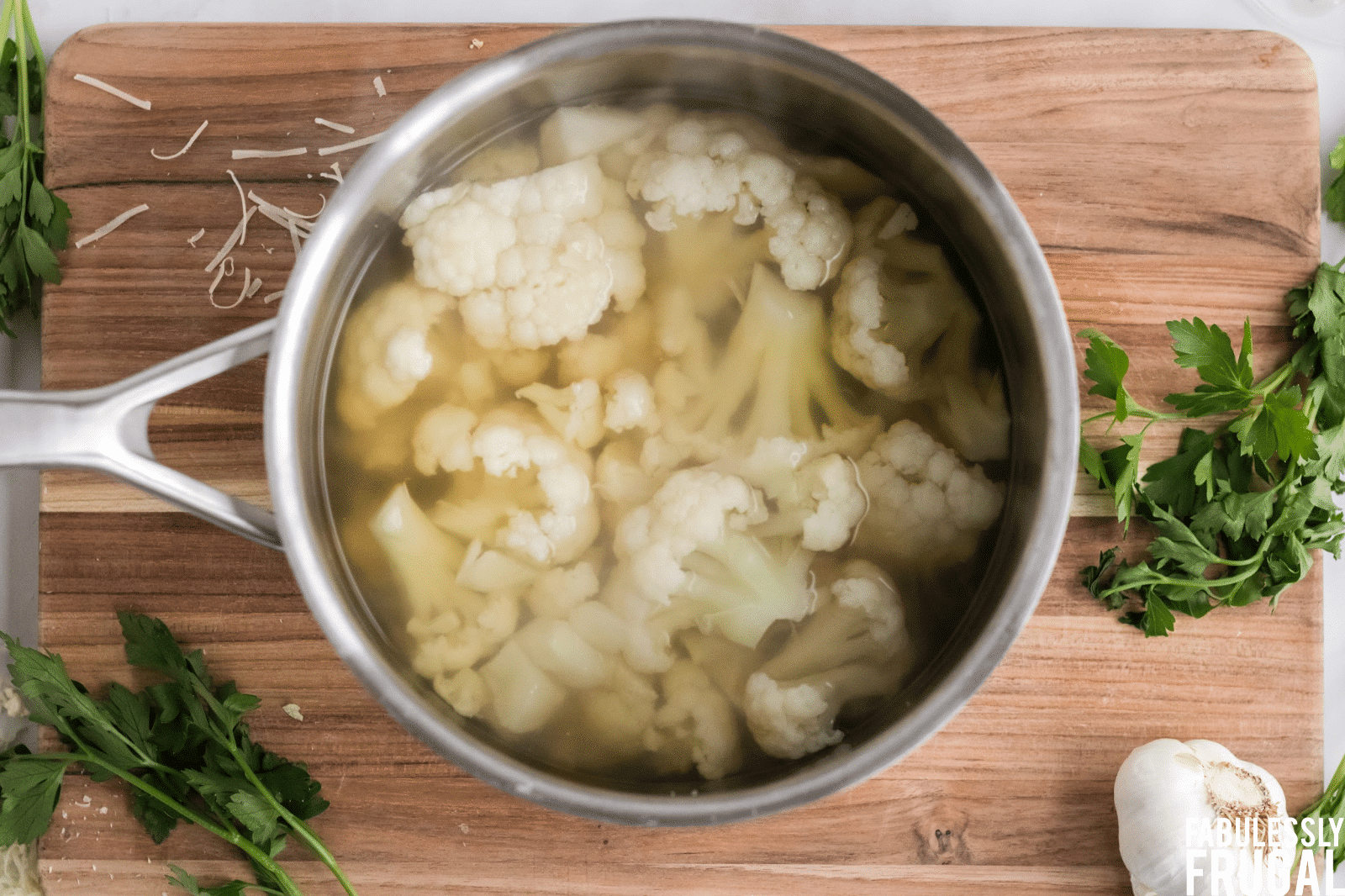 Cauliflower boiling in pot of vegetable broth