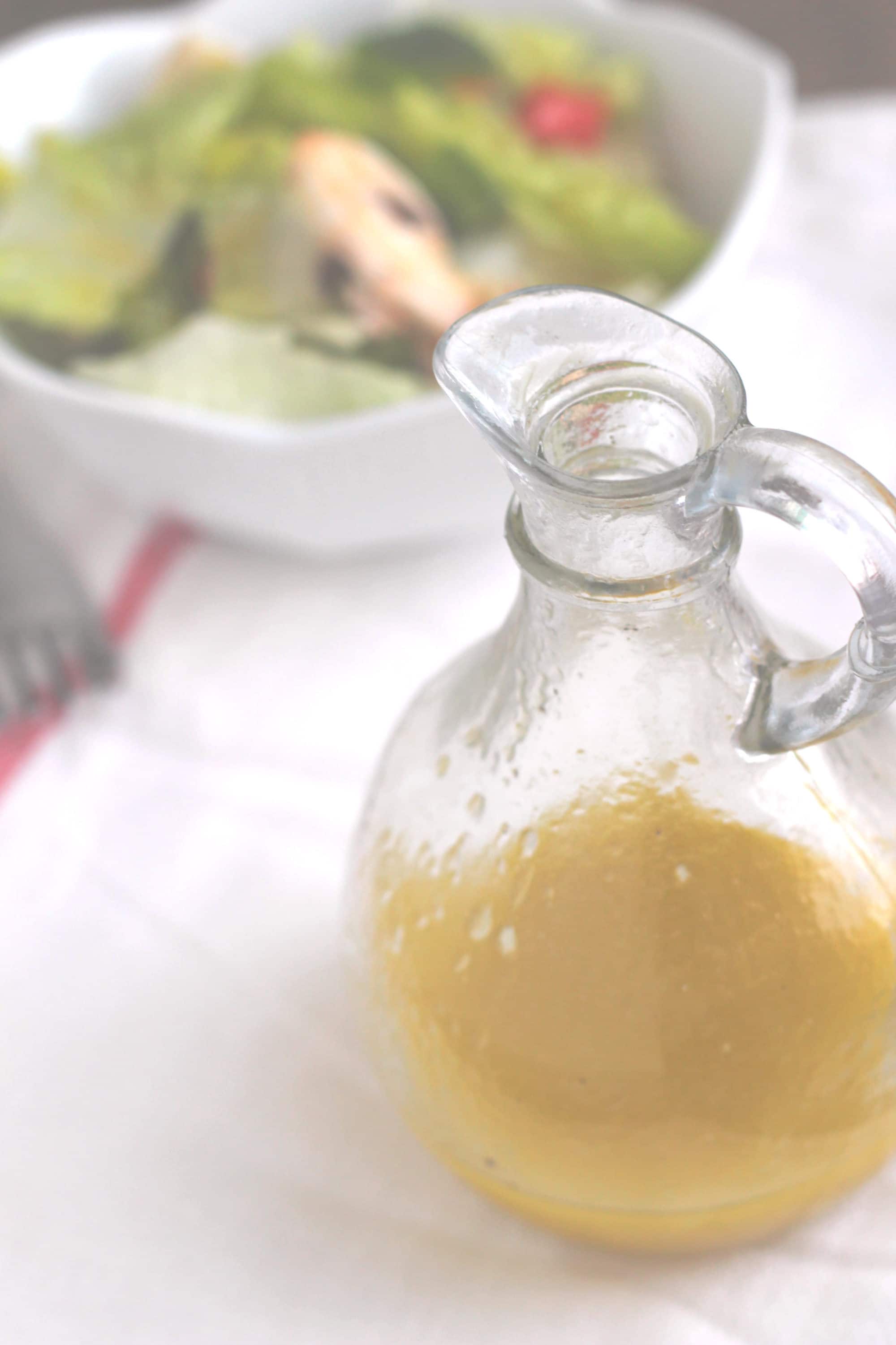 Lemon vinaigrette salad dressing in a glass container