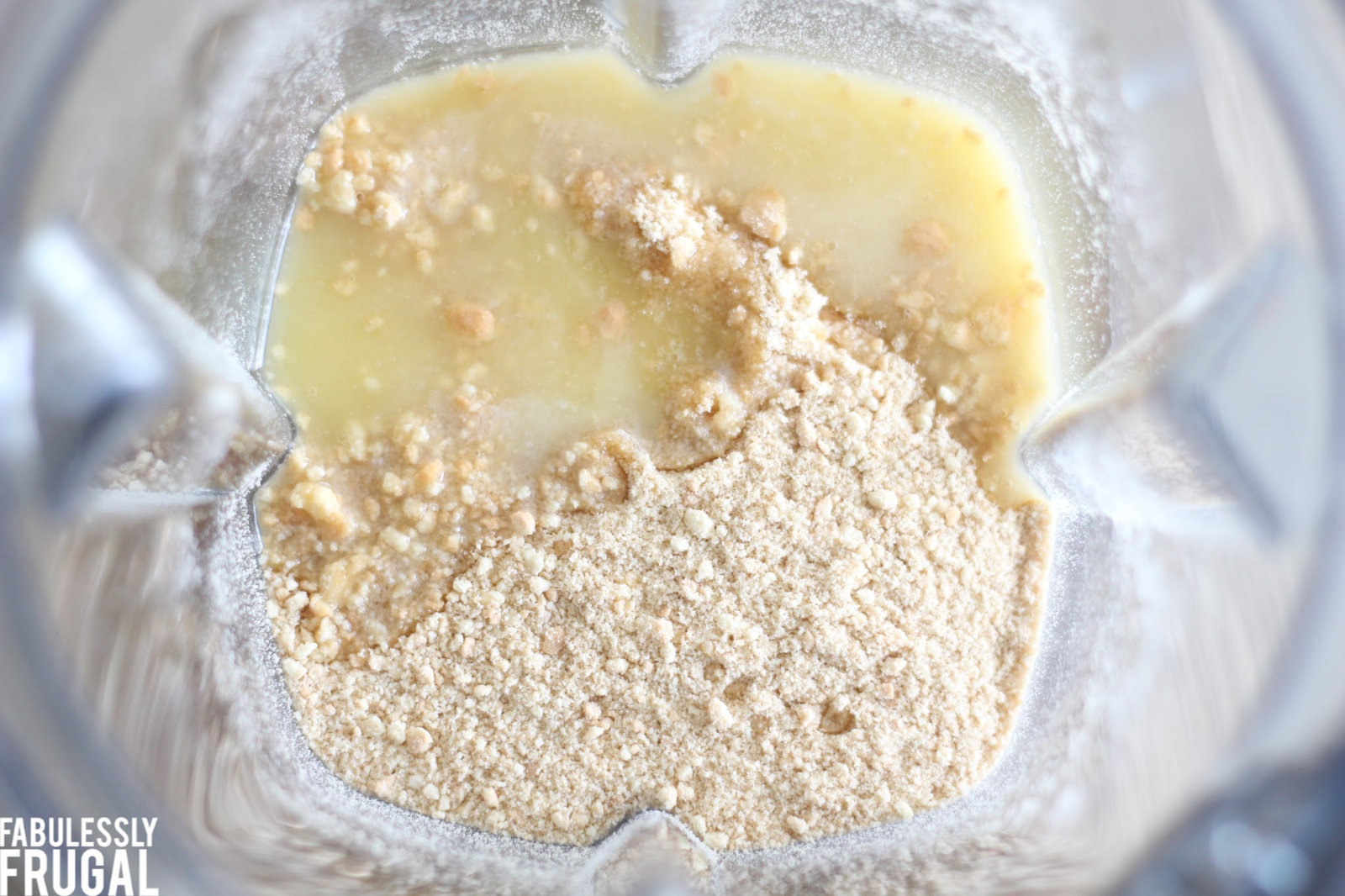 Adding melted butter to food processor with crumbs