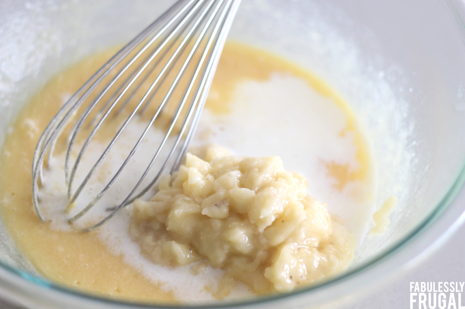 Mixing milk, mashed banana, and other ingredients