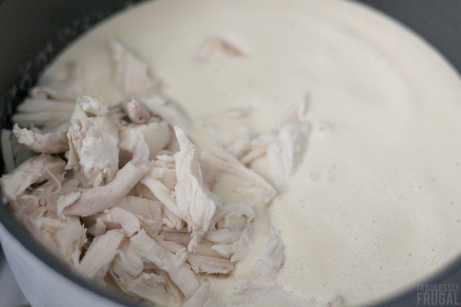 Adding shredded chicken to soup mixture