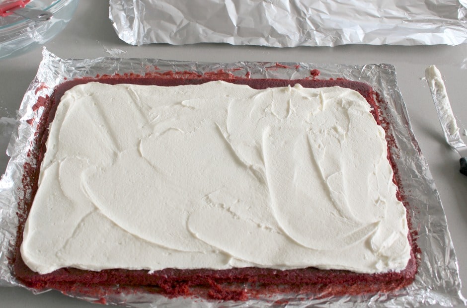 Spreading the red velvet cake roll filling